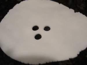 fondant ghost cupcake sheet rolled out with eyes and nose cut out