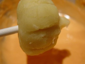 pumpkin cake pops ready for dipping in chocolate