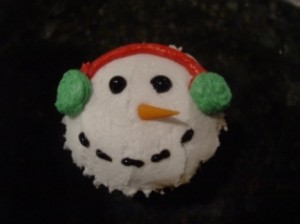 Christmas snowman cupcake with orange fondant nose and green earmuff