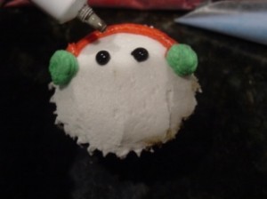 snowman cupcake with black piping gel eyes