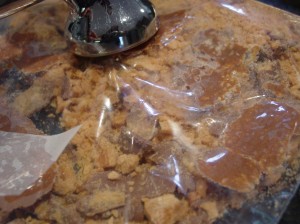 butterfinger candies being crushed in a baggie with a mallet