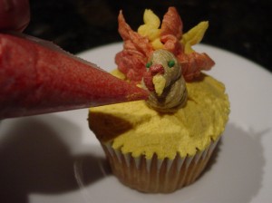 piping on a turkey beak and waddle out of icing for a turkey cupcake