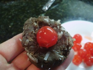 Chocolate coconut cake ball mix with marachino cherry in center