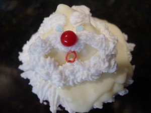 Santa cupcake step 10. Giving santa a big red nose made from a cinnamon imperial candy