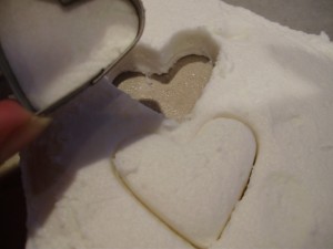 Cutting out icing heart shapes for Santa face cupcakes