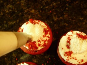 Red Velvet Cupcake with figure piped heart made from cake icing.