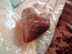 Red Velvet Cake Ball being shaped into a heart